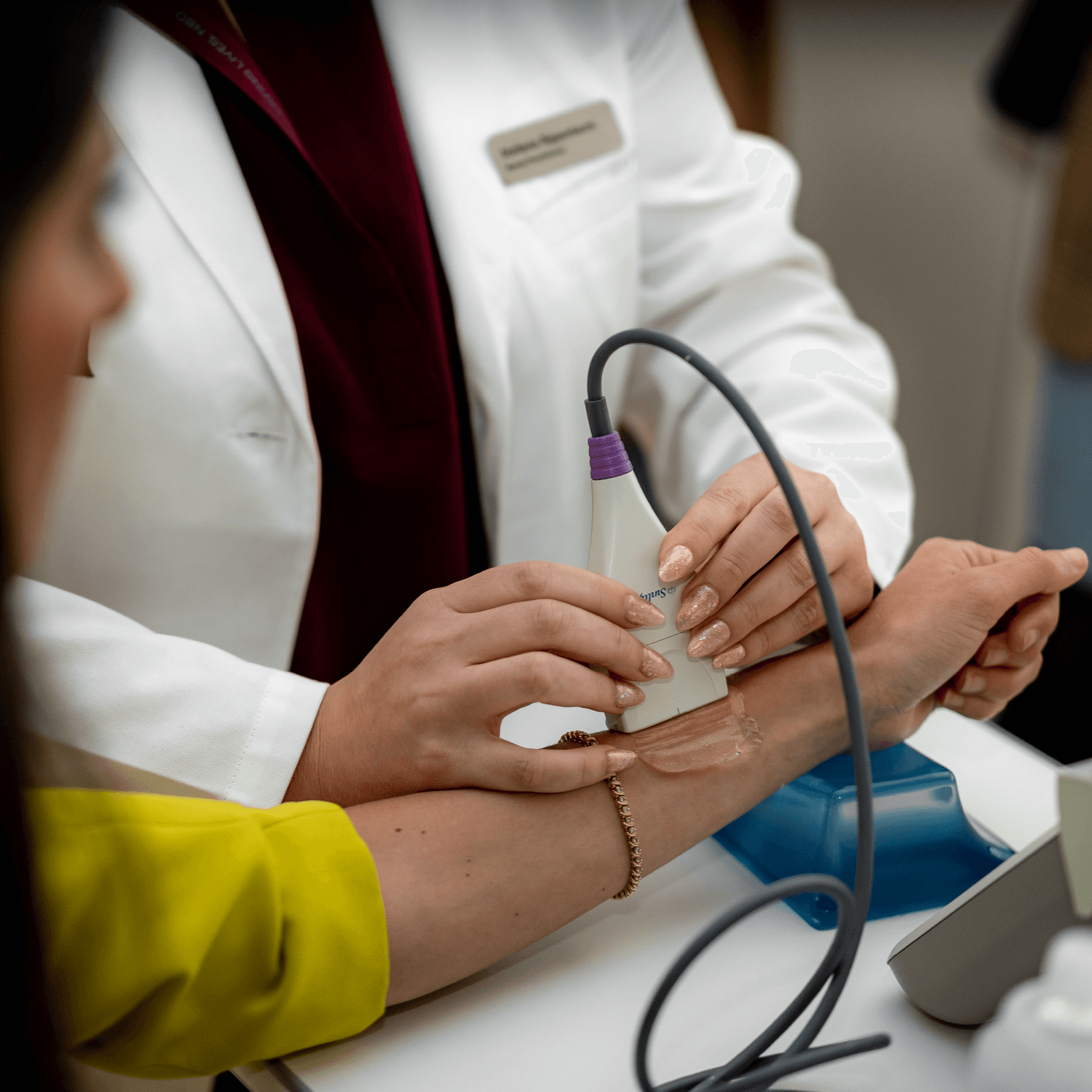 A clinician placing a bone-density sensor on a client's wrist